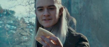 Legolas holding a piece of lembas.